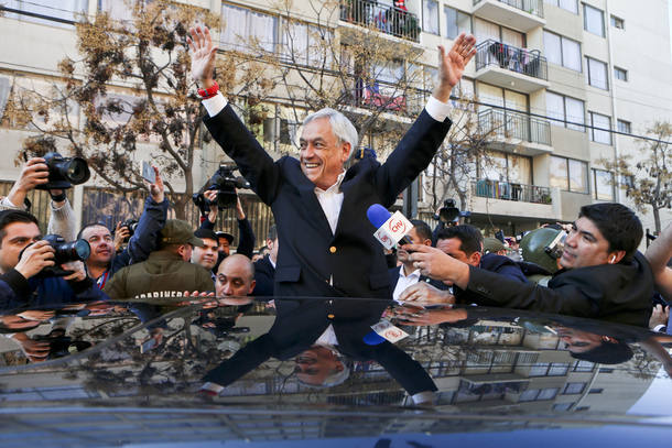 In this July, 2, 2017 photo, former Chilean President and presidential candidate for a coalition parties called Chile Vamos, Sebastian Pinera, waves to supporters after voting during a primary elections in Santiago, Chile. This is the third time Pinera runs for President, having lost once to current President Michelle Bachelet and then winning the presidency on a second run. (AP Photo/Esteban Felix)